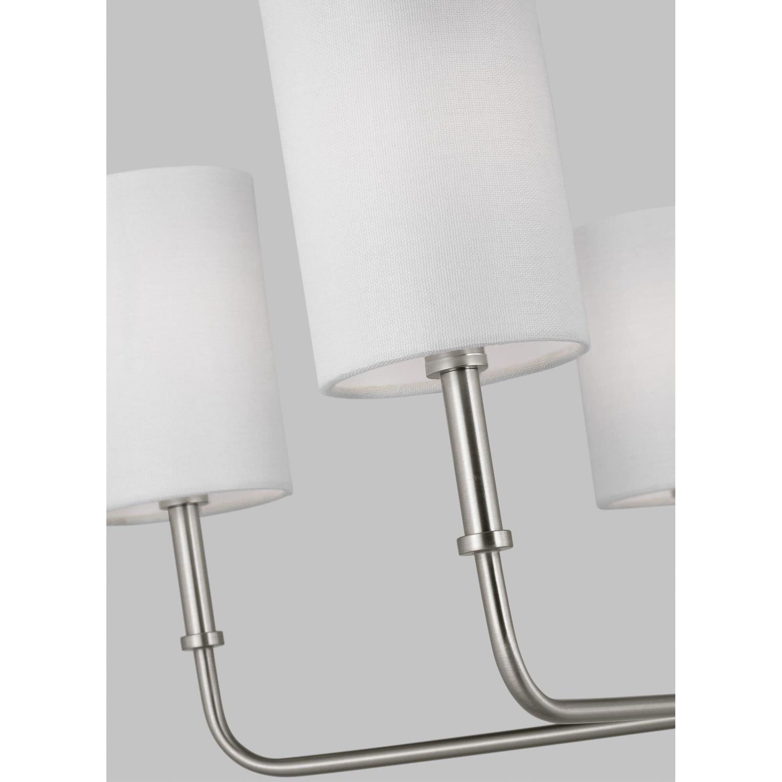 Foxdale white fabric shades on curved nickel-coloured arms