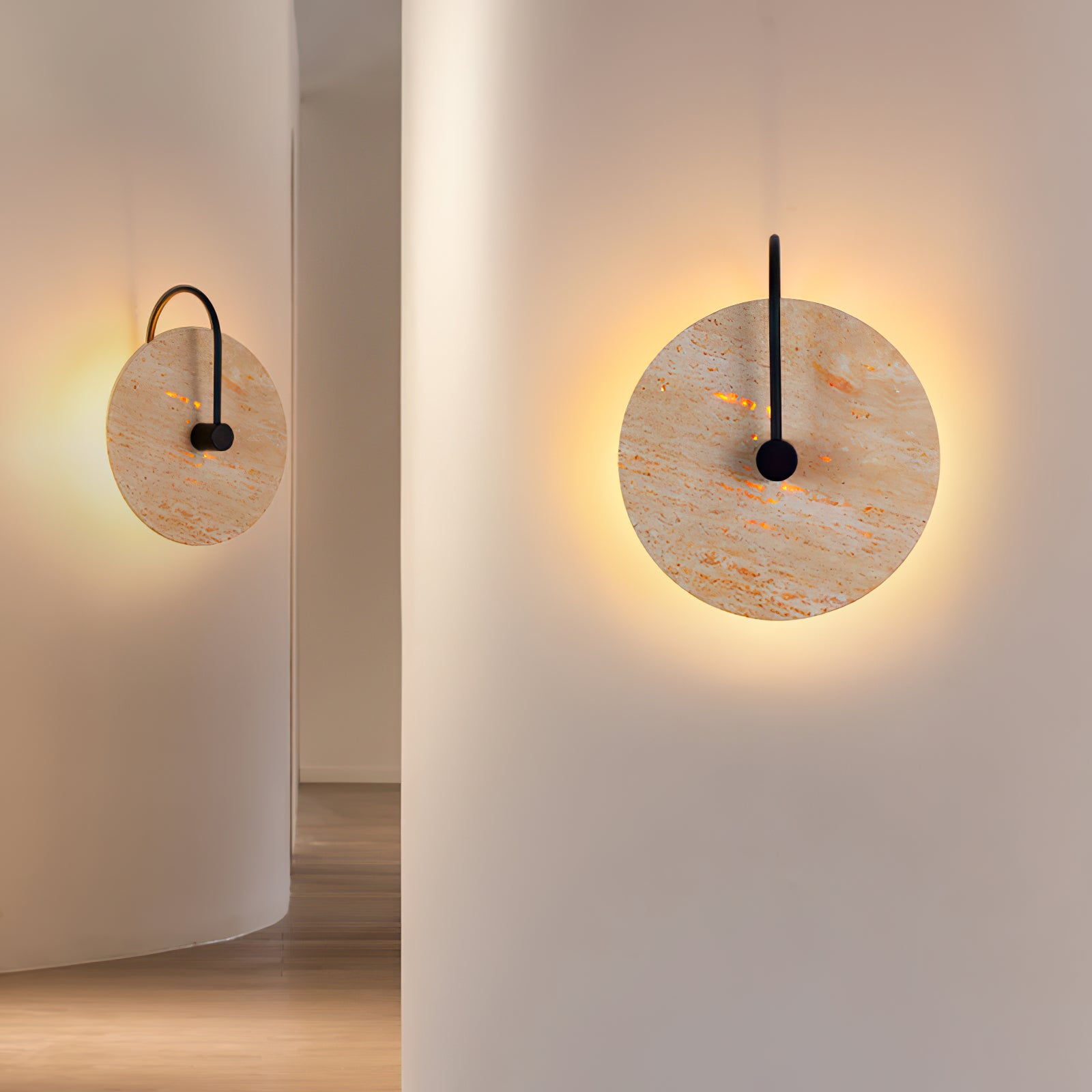 Two matching round stone lights on separate wall faces