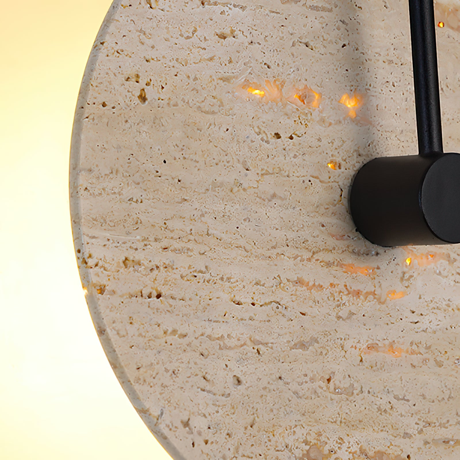 Detail of backlit stone texture and black central fitting