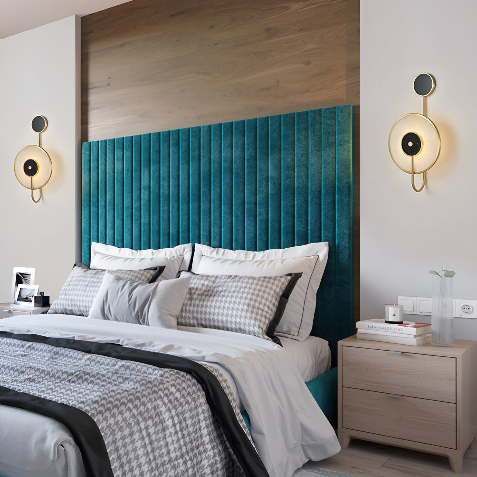 Pair of black-and-white stone lamps beside a teal headboard