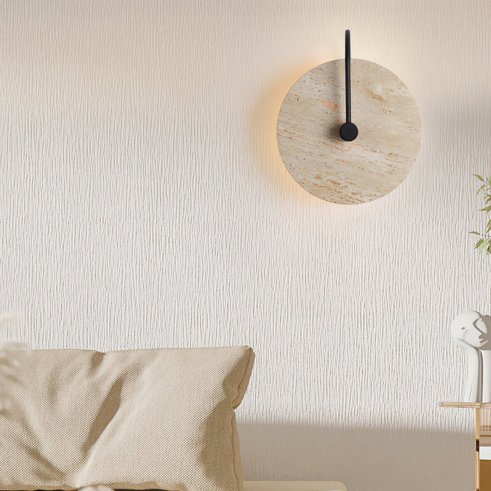 Round stone wall light beside an upholstered bed