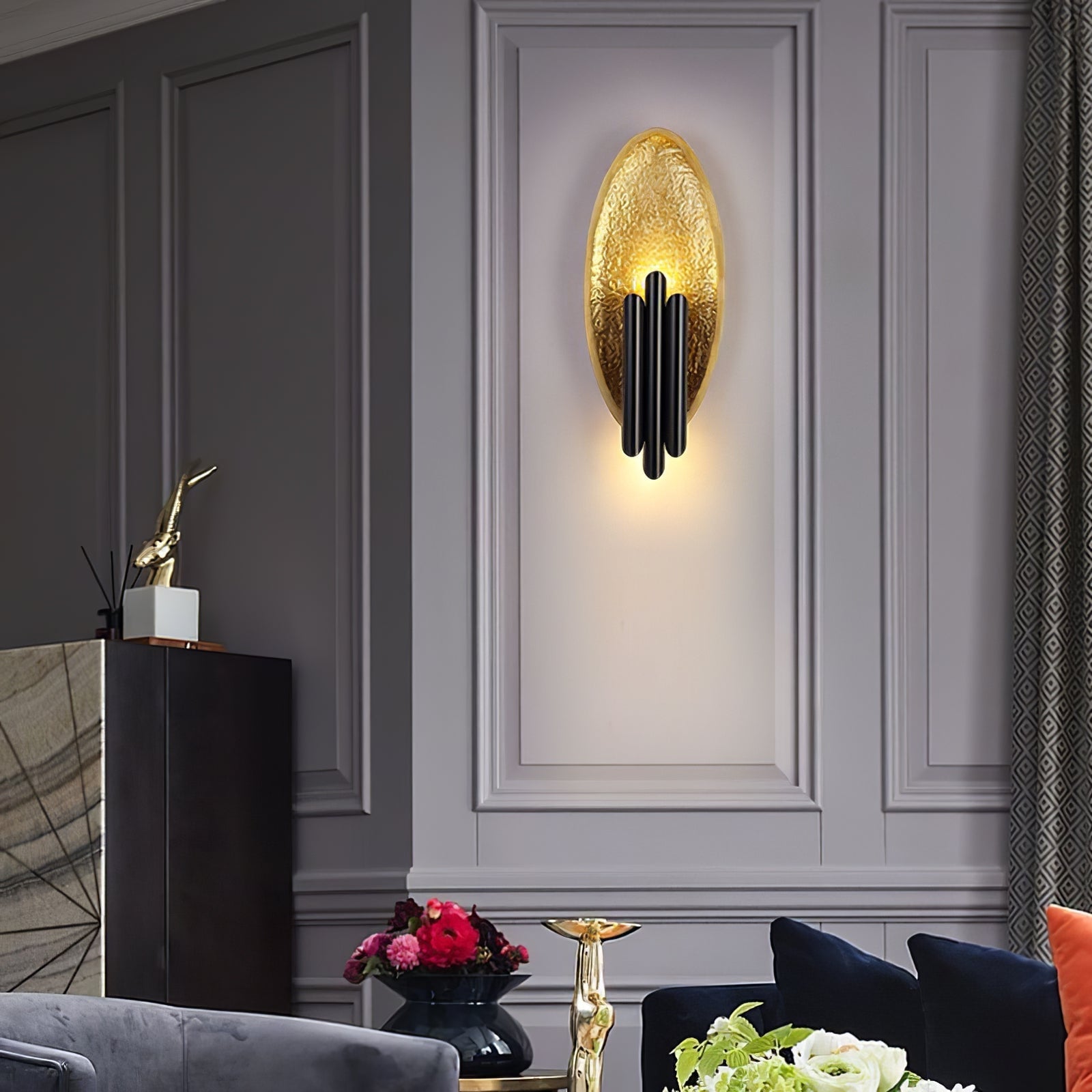 Gold textured oval and black bars on a grey paneled wall