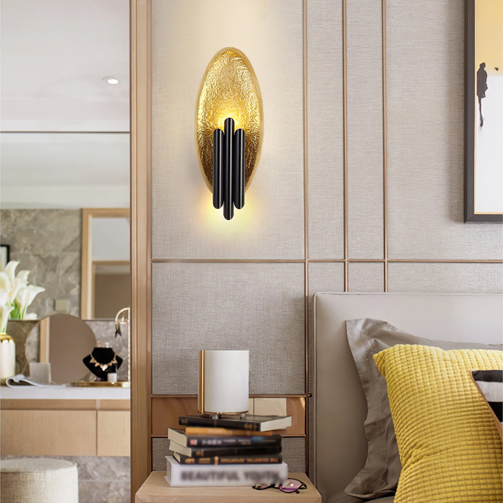 Gold textured wall lamp with black bars near a bedside table