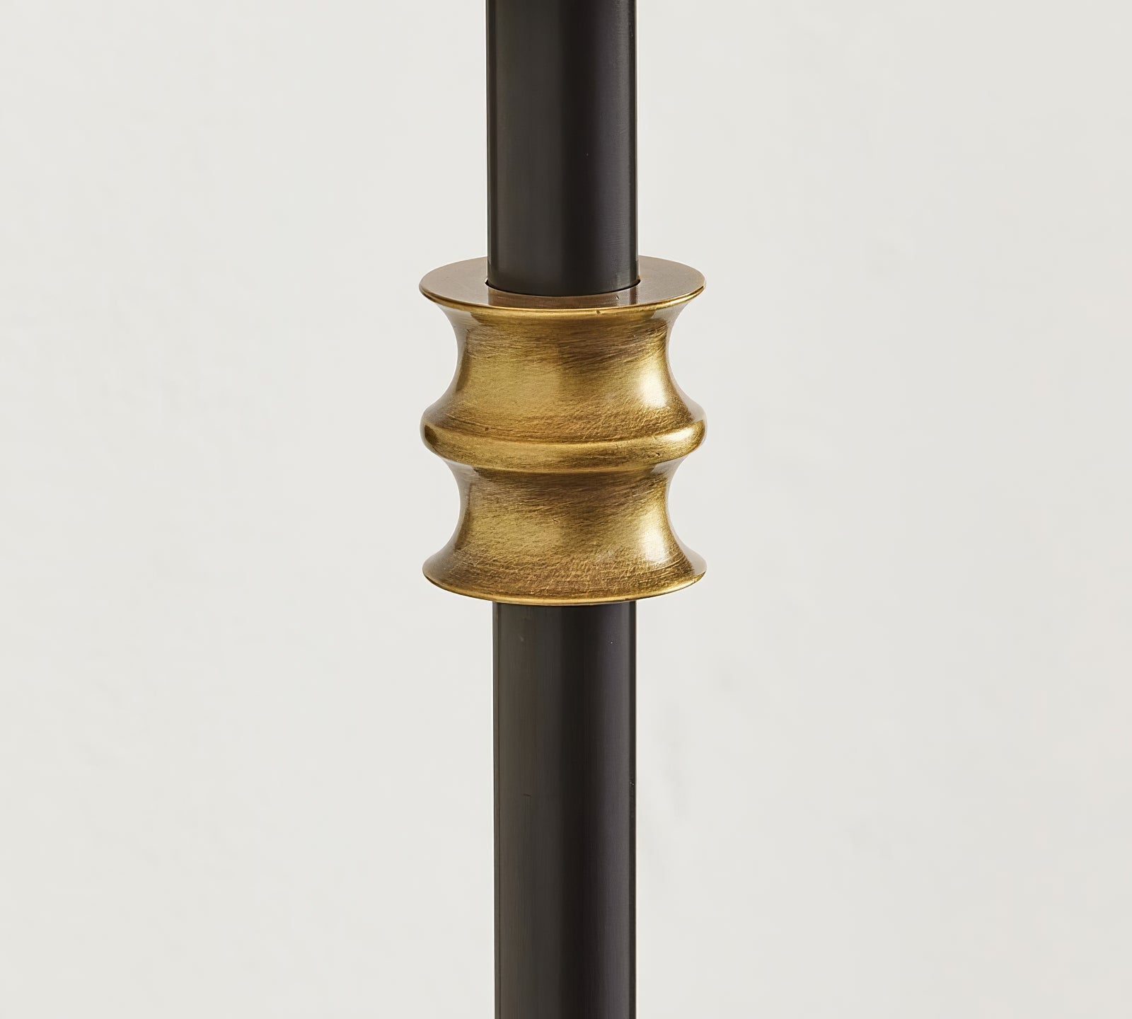 Warm-metal accent collar on the black Collins arm