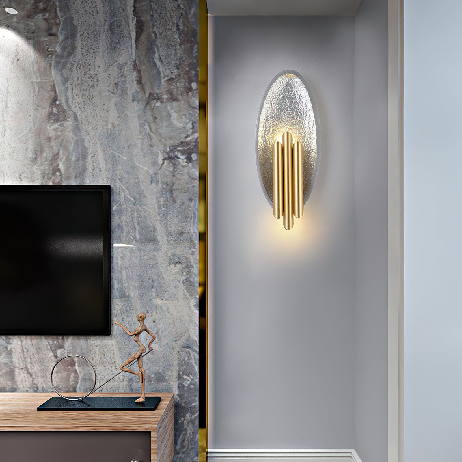 Silver textured oval wall lamp with gold bars beside a television