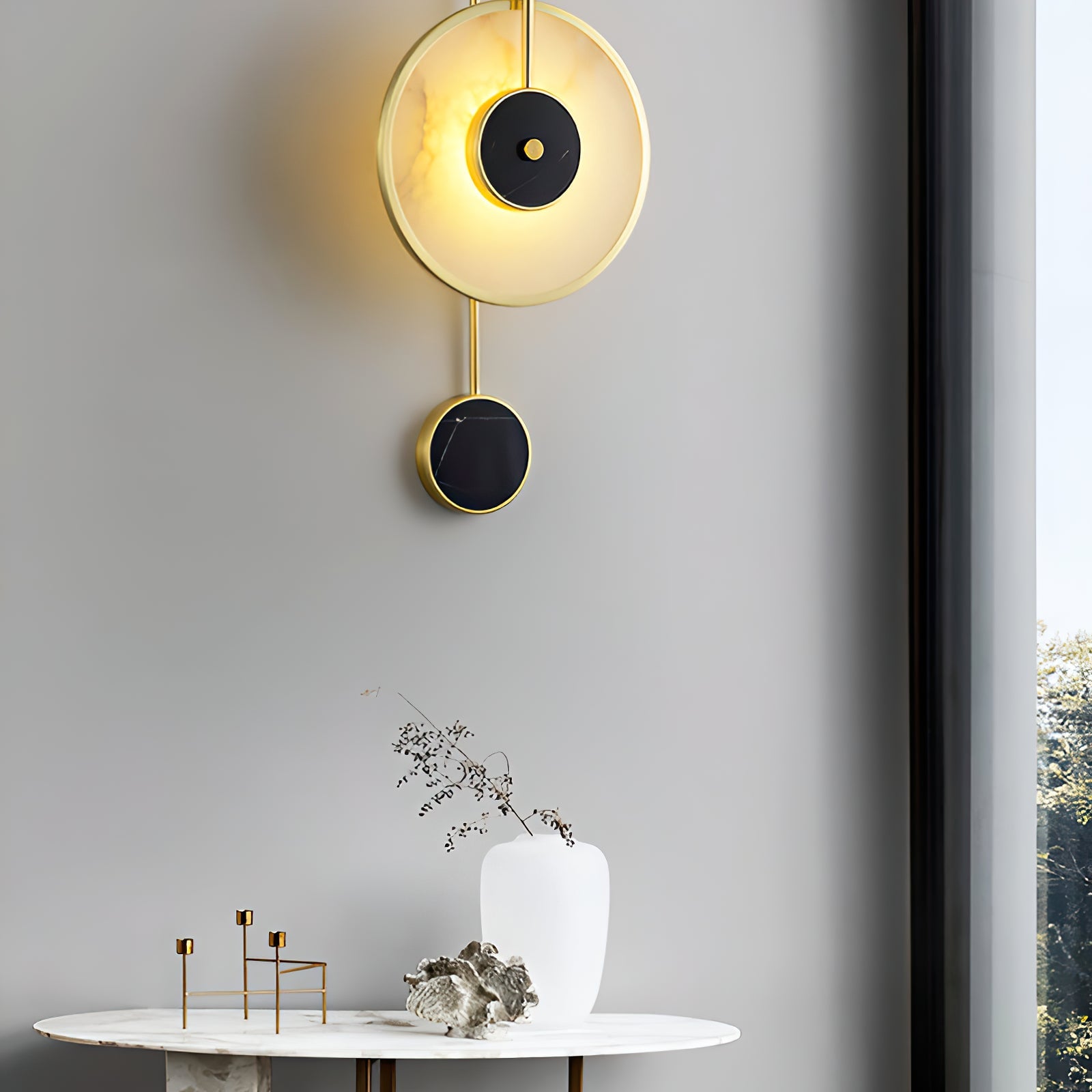 Circular wall lamp with lower black accent above a table