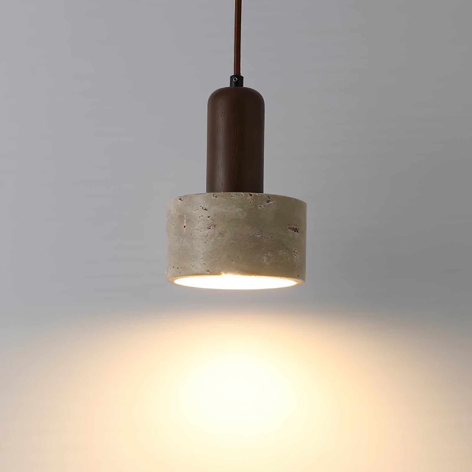 Illuminated underside of a hanging stone cylinder shade