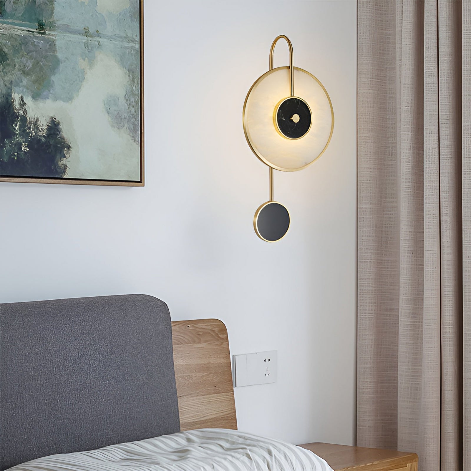 Stone circle wall light with upper loop and lower black disc