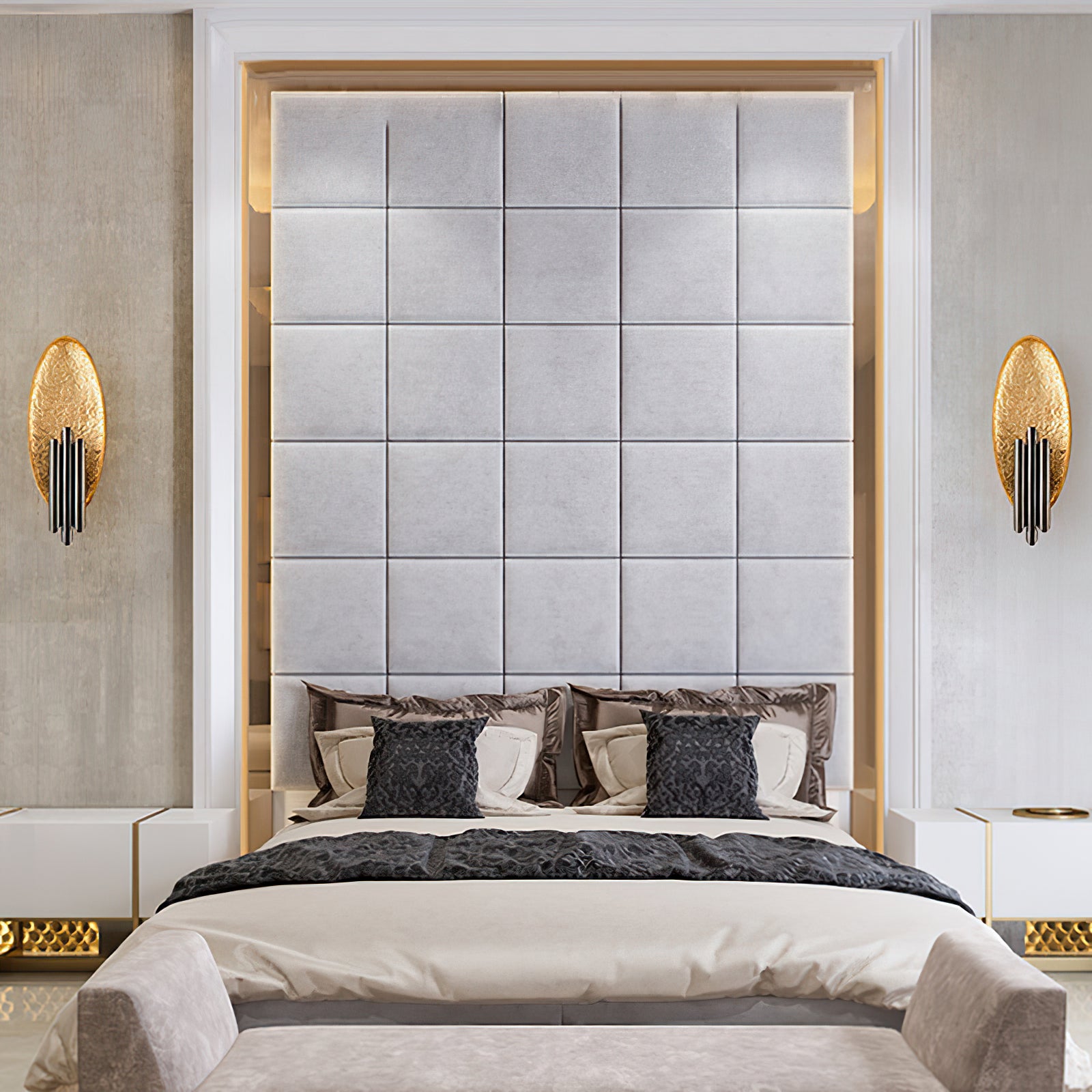 Pair of black-and-gold oval wall lights beside a bed