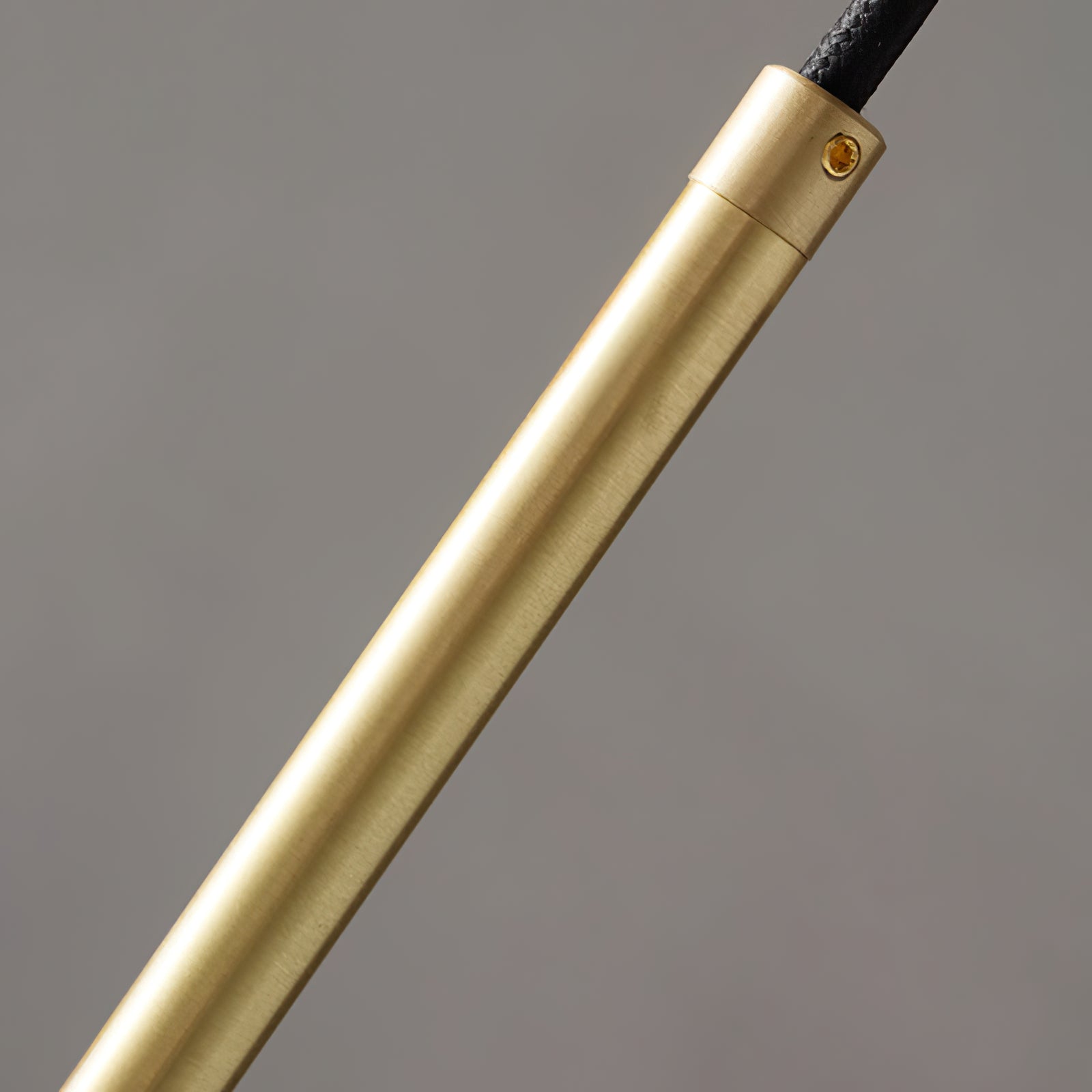 Close-up of the metallic pendant stem and cable connection