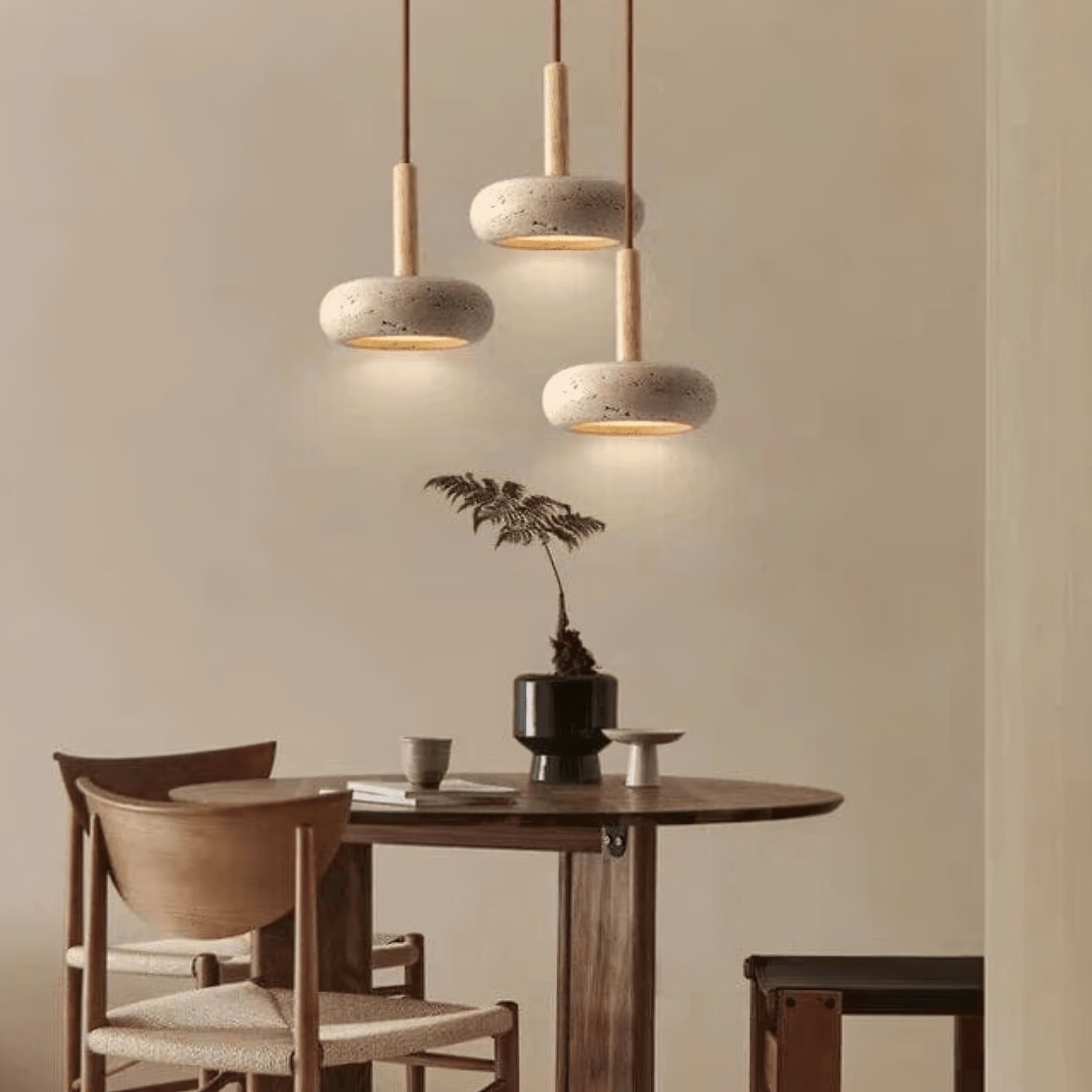 Three small stone-and-wood pendants over a round table