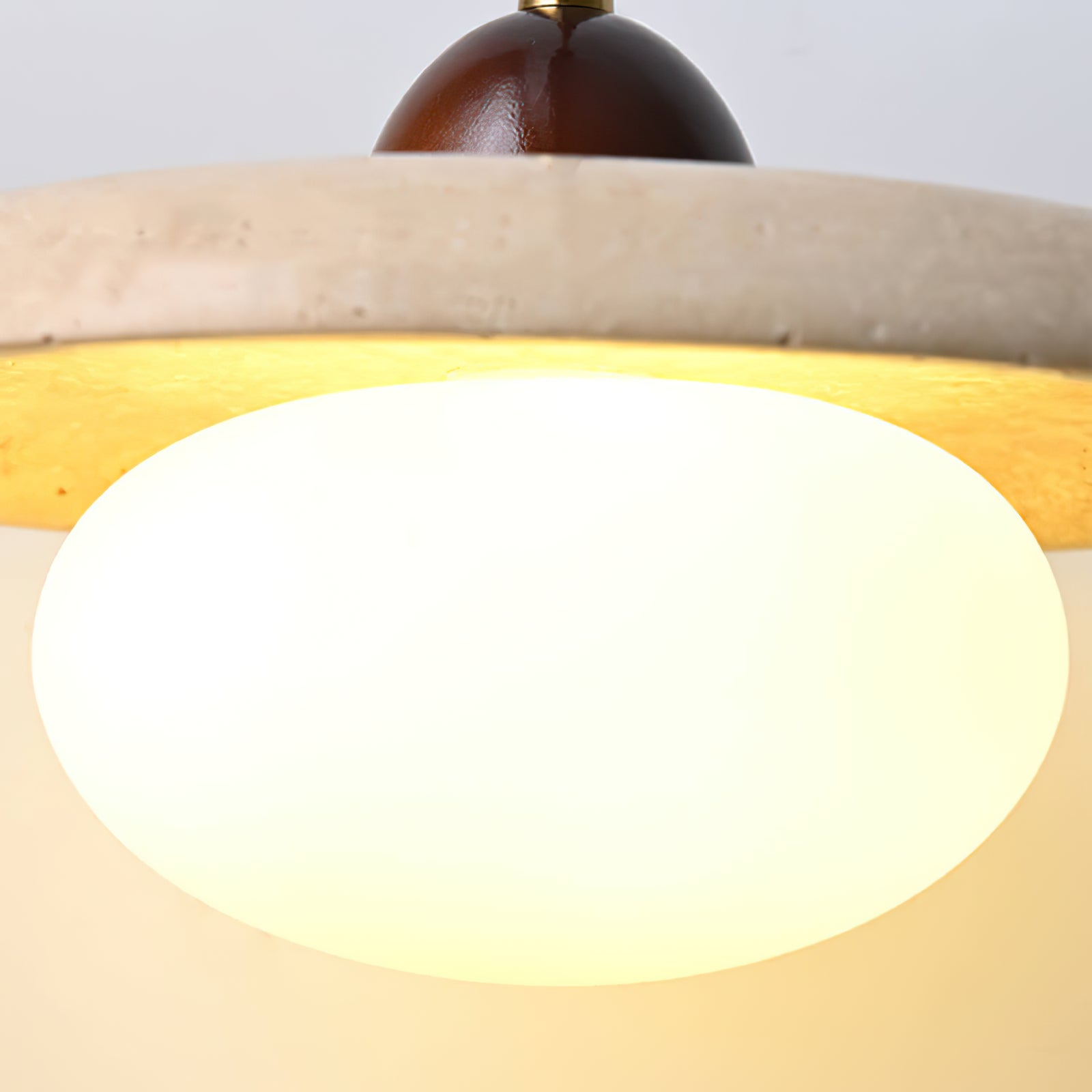 Illuminated glass diffuser below the textured stone disc