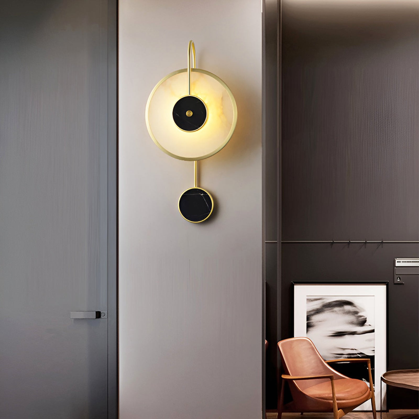 Lit stone wall lamp with small black disc below the main circle