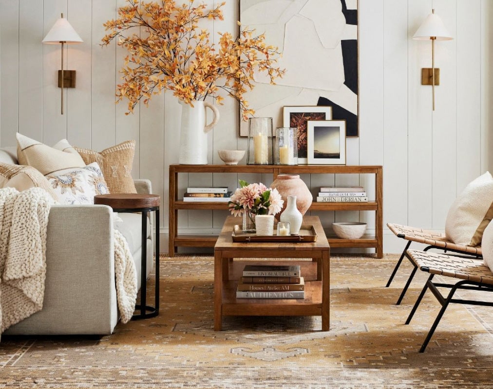 Gold Ellis sconces beside living-room seating