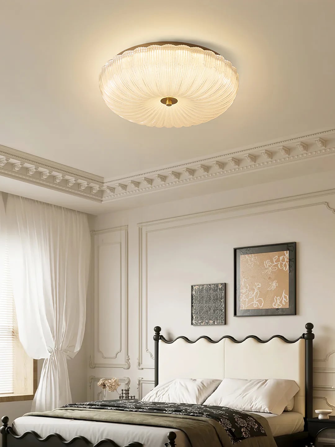 Warm-looking ribbed glass ceiling light above a bed