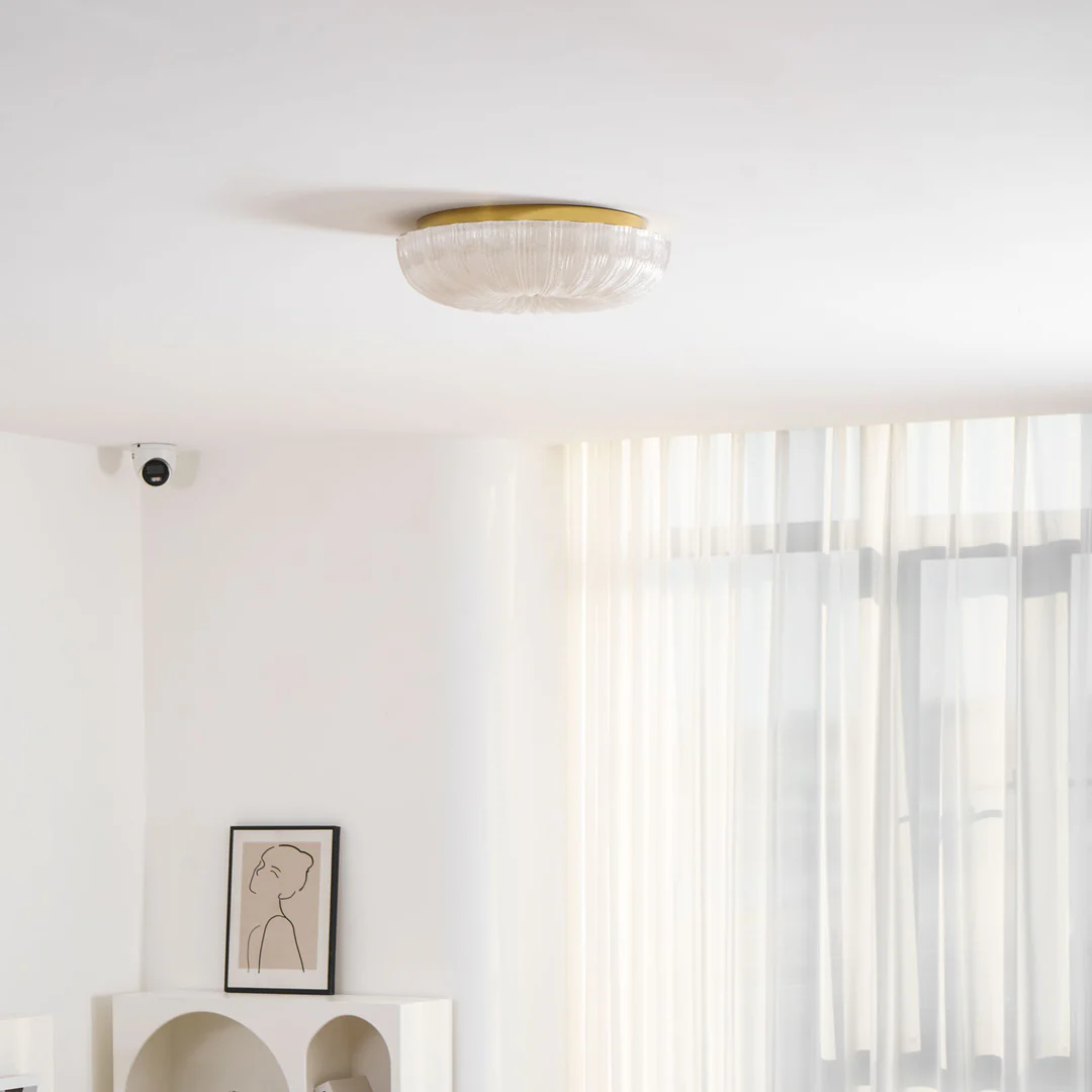 Ripple ceiling light above a vase and round table