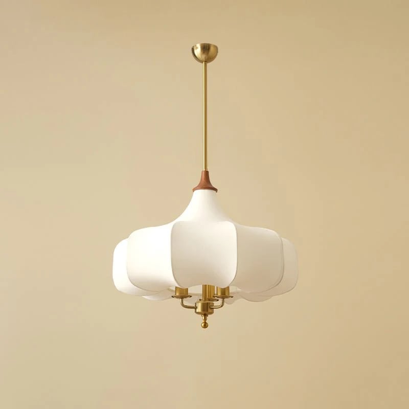 Close view of plain white rounded fabric shade and gold-toned lower fittings