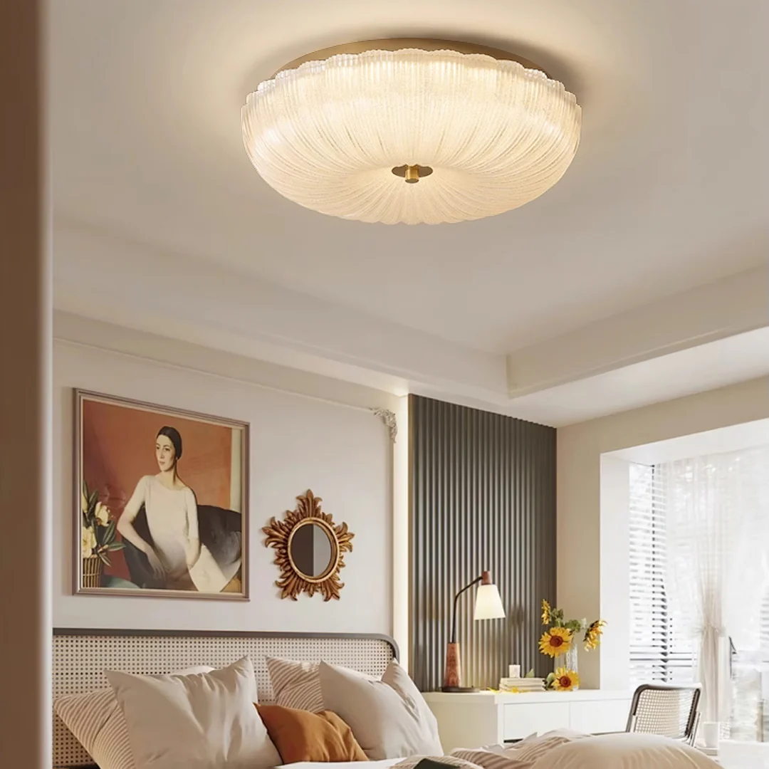 Ripple ceiling light with gold details above bedding