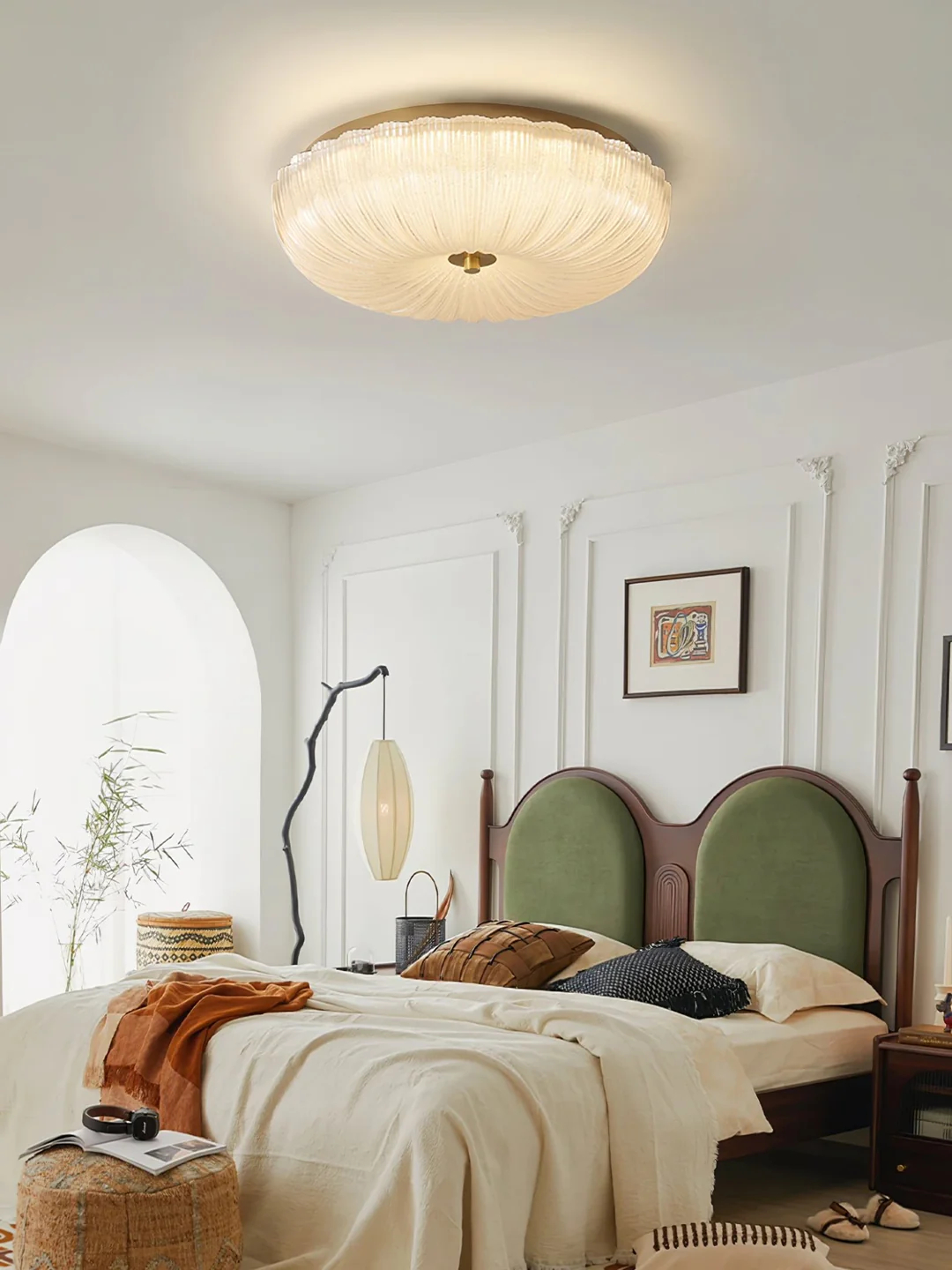Round glass fixture above a softly furnished bedroom