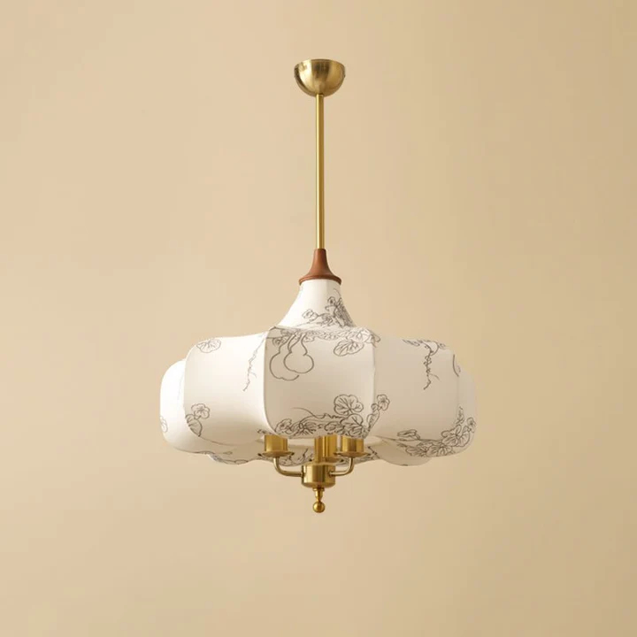 Patterned pendant hanging by a chain against a beige background