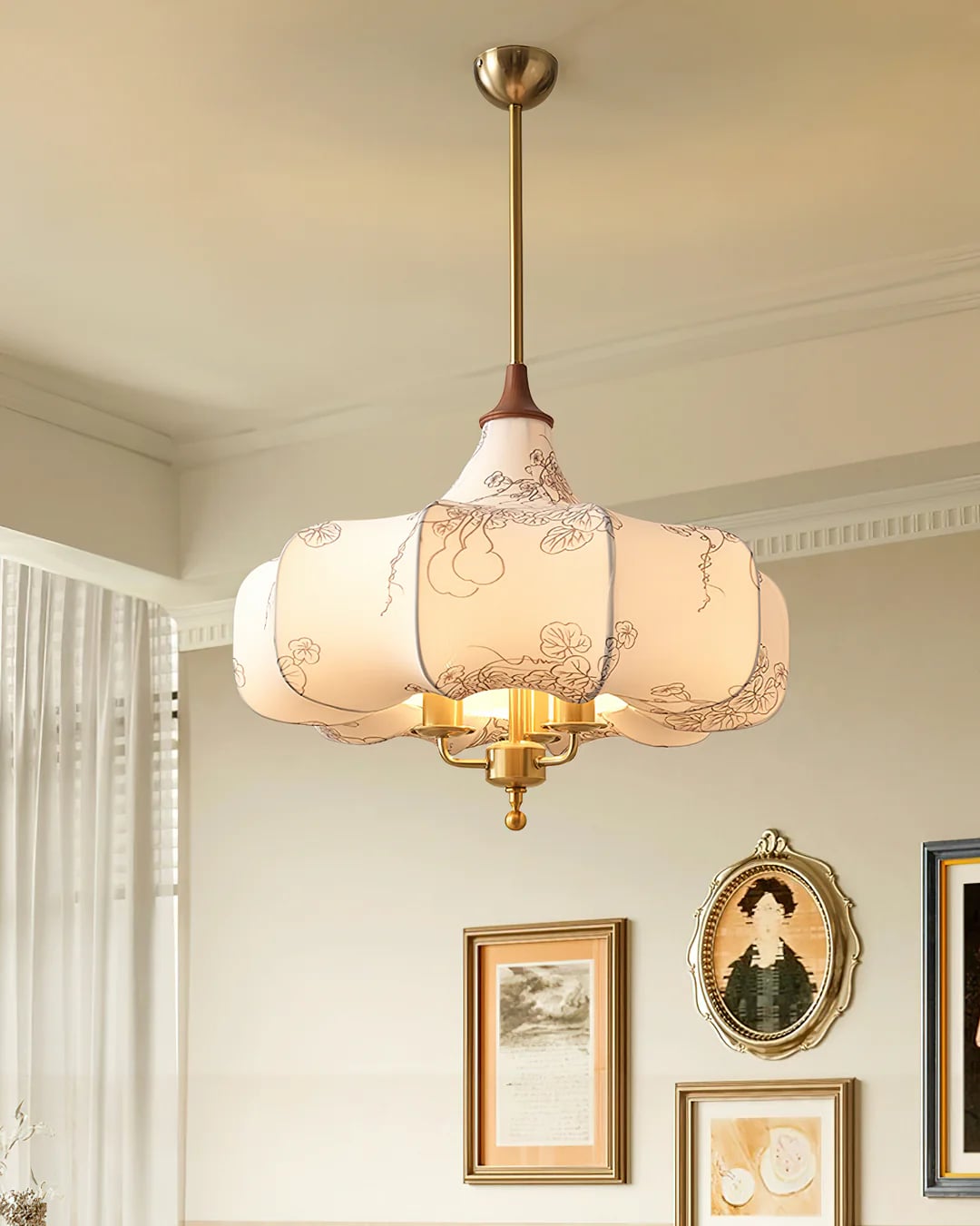 Patterned fabric pendant beside framed wall pictures