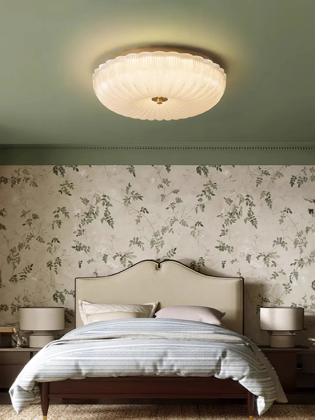 Ribbed ceiling light above a bed with floral wallpaper