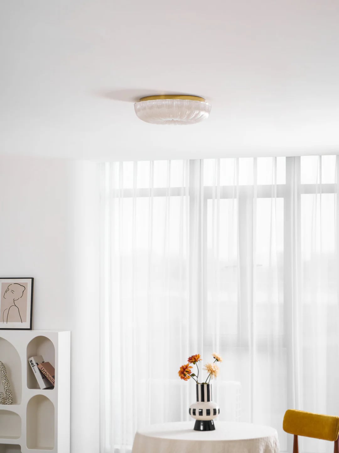 Shallow Ripple ceiling light above a round table
