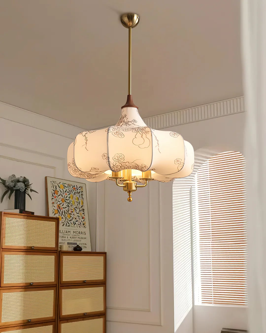 Patterned fabric shade pendant beside a chest of drawers