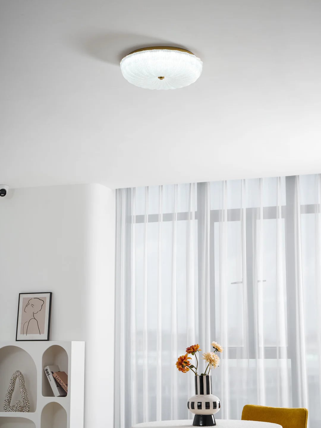 Round glass ceiling light in a bright room