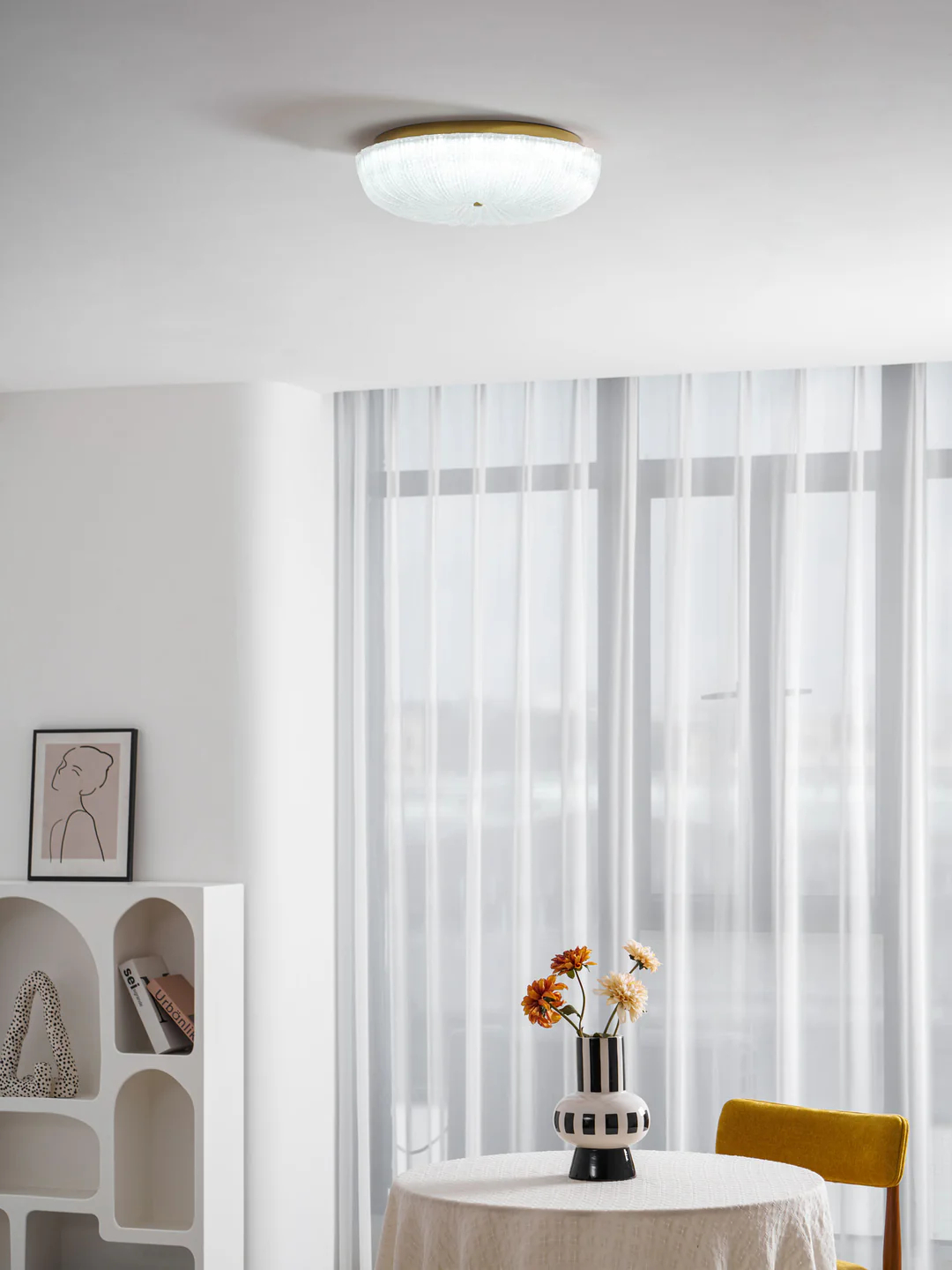 Frosted glass ceiling light near a curtained window