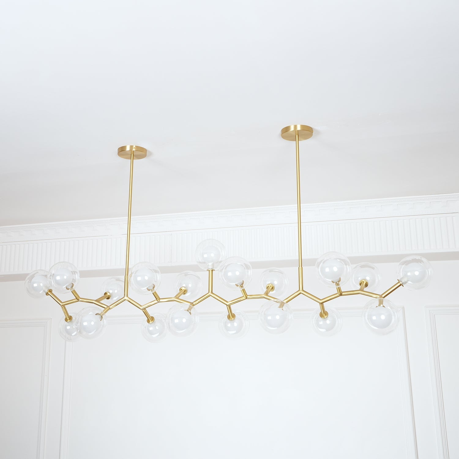 Wide gold branch chandelier with transparent spherical shades